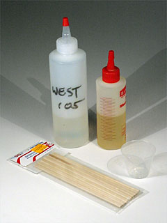 epoxy resin, hardener, mixing cup and mixing stick